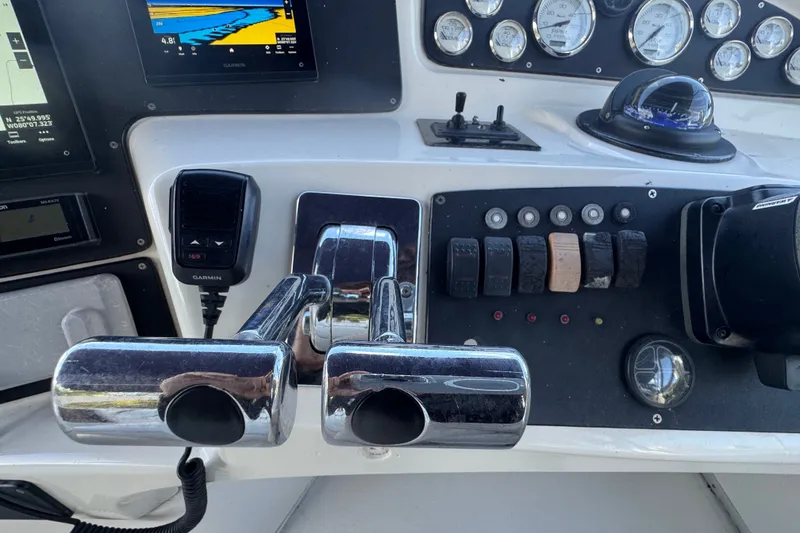 Slide: The Image of Control panel of a 2002 Silverton 410 Sport Bridge with navigation and throttle controls. - 22