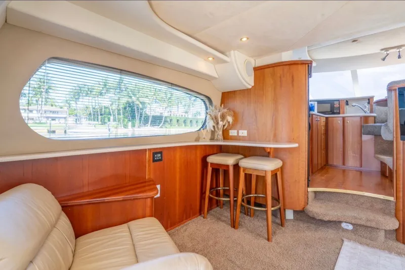 Slide: The Image of Luxurious interior of 2002 Silverton 410 Sport Bridge yacht with elegant wood finishes. - 12