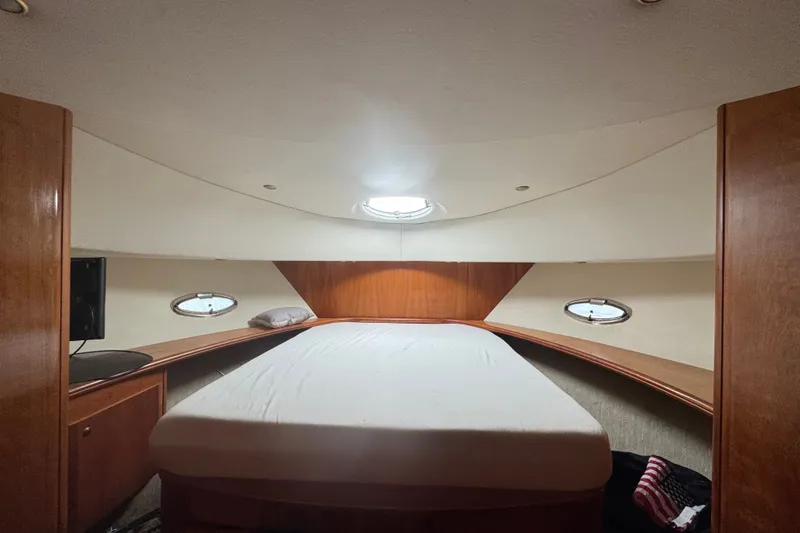 Slide: The Image of Interior cabin of a 2002 Silverton 410 Sport Bridge yacht with a cozy bed. - 41