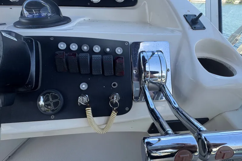Slide: The Image of Control panel of a 2002 Silverton 410 Sport Bridge boat with throttle levers. - 23