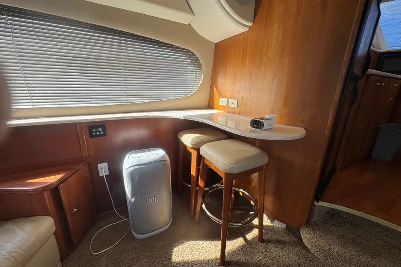 Slide: The Image of Interior of 2002 Silverton 410 Sport Bridge with bar stools and JBL speaker. - 32