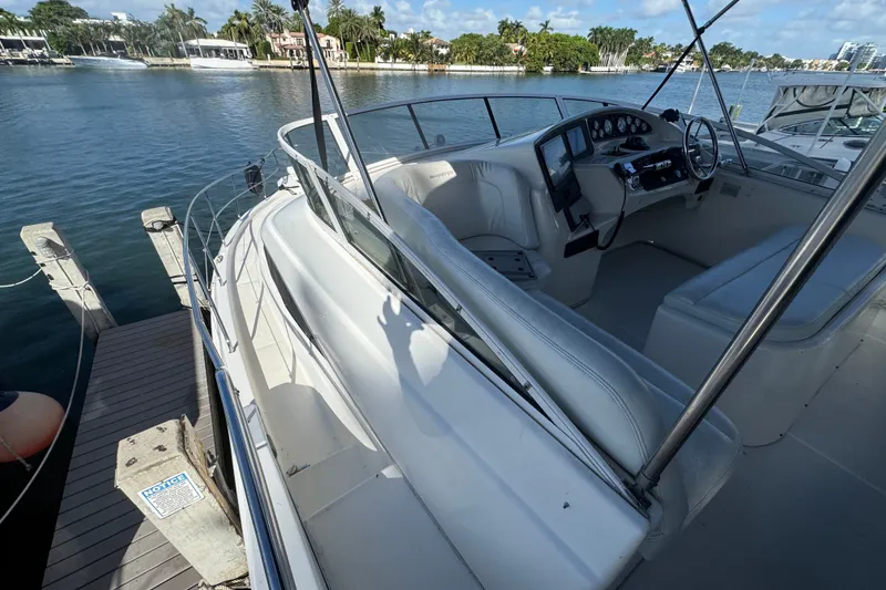 Slide: The Image of 2002 Silverton 410 Sport Bridge yacht docked by scenic waterfront. - 24