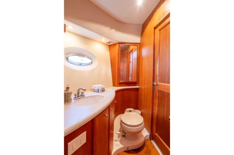Slide: The Image of Luxurious 2002 Silverton 410 Sport Bridge yacht bathroom with wooden cabinetry and modern fixtures. - 19