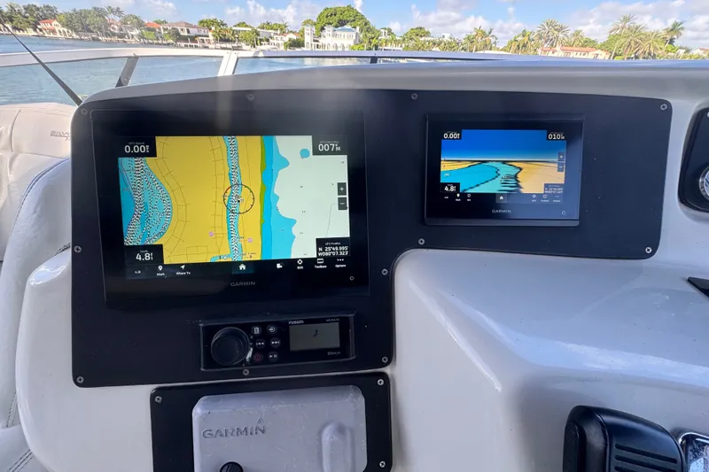 Slide: The Image of Garmin navigation screens on a 2002 Silverton 410 Sport Bridge boat dashboard. - 16