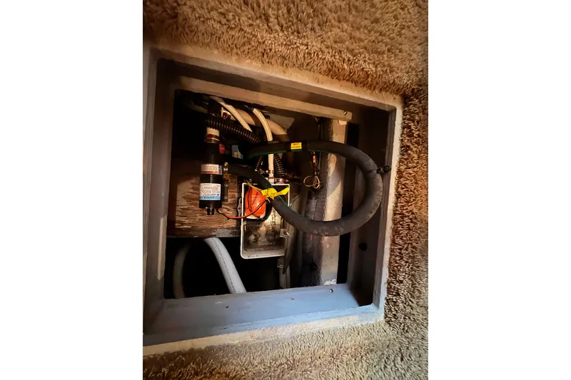 Slide: The Image of Electrical compartment inside a 2002 Silverton 410 Sport Bridge boat, showing wiring and components. - 59