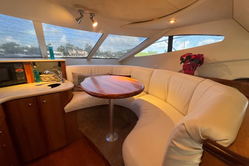 Slide: The Image of Luxurious interior of 2002 Silverton 410 Sport Bridge with plush seating and kitchenette. - 34