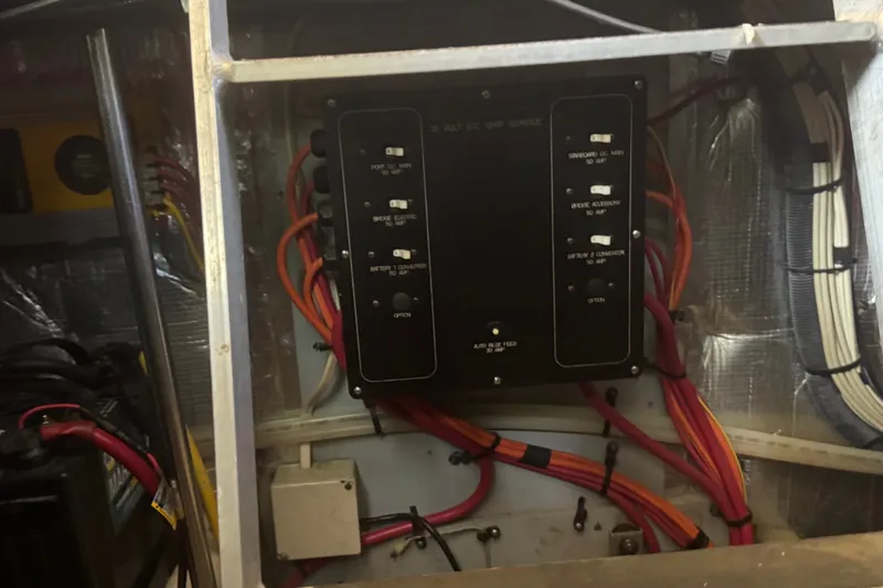 Slide: The Image of Electrical panel with wiring inside a 2002 Silverton 410 Sport Bridge boat. - 54