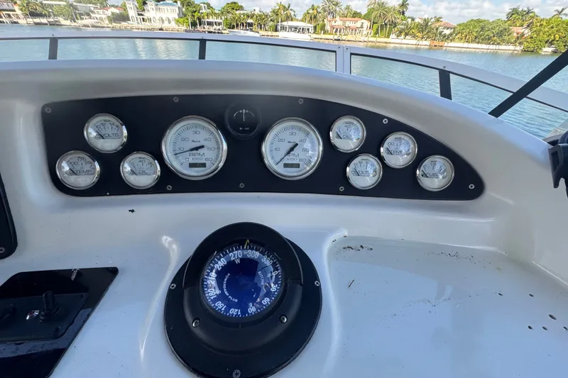 Slide: The Image of Dashboard of a 2002 Silverton 410 Sport Bridge with gauges and compass. - 21