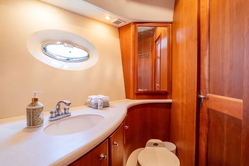 Slide: The Image of Luxurious bathroom interior of 2002 Silverton 410 Sport Bridge yacht with wooden cabinetry. - 10