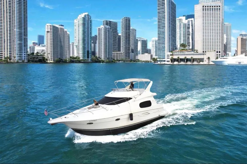 Slide: The Image of 2002 Silverton 410 Sport Bridge cruising in urban waterfront with skyscrapers. - 1