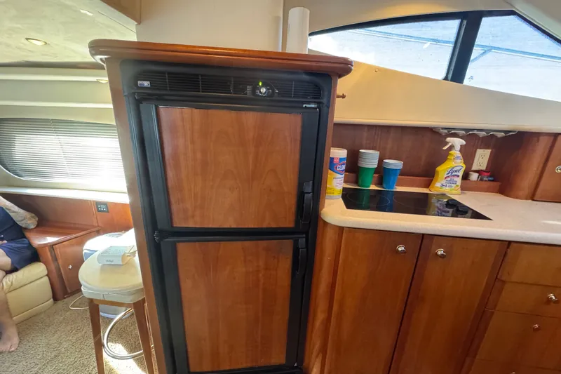 Slide: The Image of Interior of 2002 Silverton 410 Sport Bridge with kitchenette and wooden cabinetry. - 35
