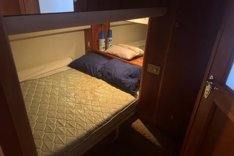 Slide: The Image of Cozy cabin interior of 2002 Silverton 410 Sport Bridge with bed and pillows. - 49