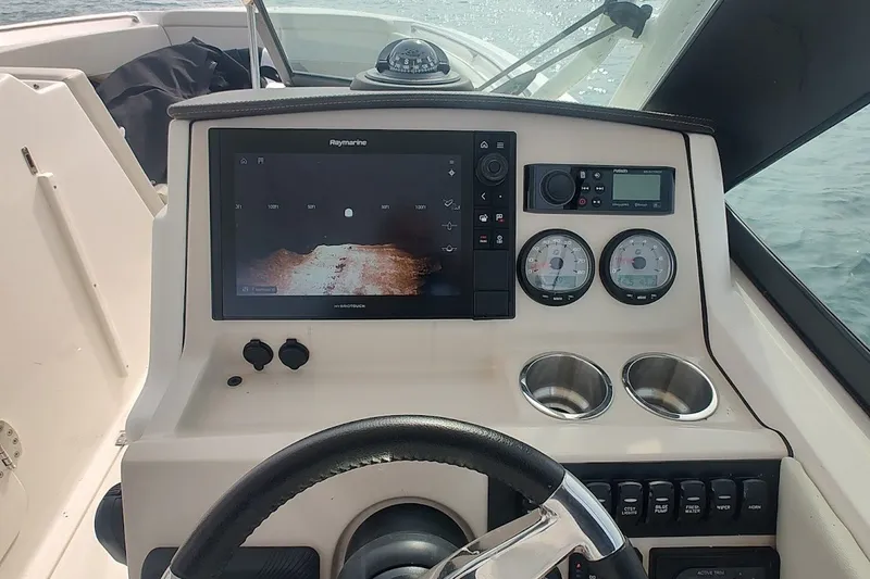 Slide: The Image of Control panel of a 2022 Boston Whaler 240 Vantage boat with navigation display. - 29