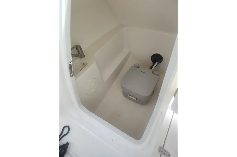 Slide: The Image of Interior of 2022 Boston Whaler 240 Vantage boat with portable toilet. - 34