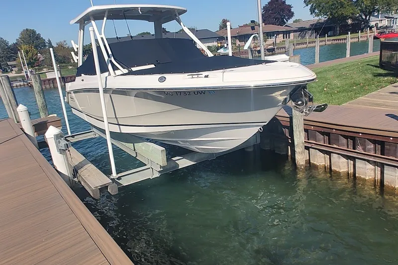 Slide: The Image of 2022 Boston Whaler 240 Vantage boat on lift at dockside. - 27