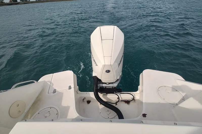 Slide: The Image of 2022 Boston Whaler 240 Vantage boat engine on calm water. - 36