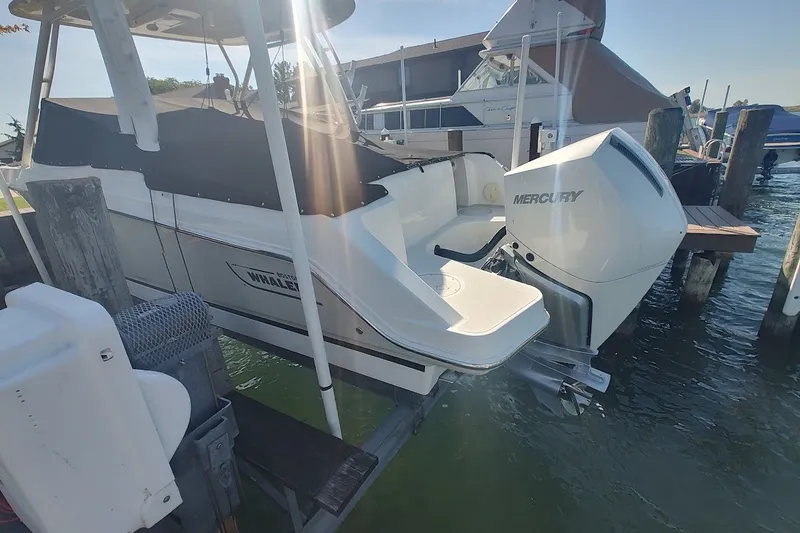 Slide: The Image of 2022 Boston Whaler 240 Vantage with Mercury engine docked at marina. - 24
