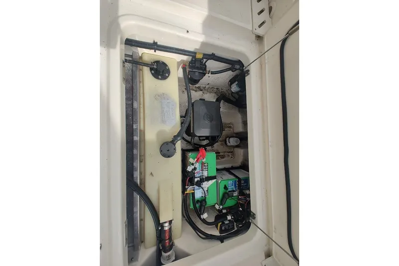 Slide: The Image of 2022 Boston Whaler 240 Vantage engine compartment with battery and wiring components. - 38