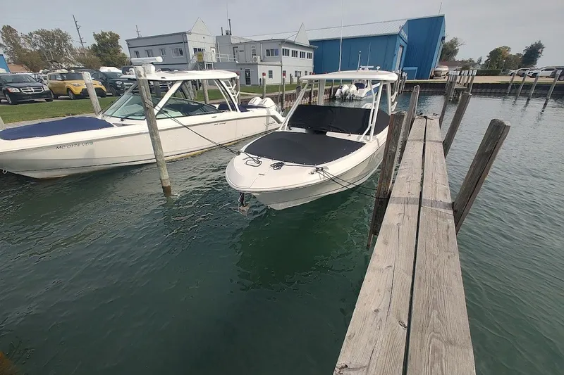 Slide: The Image of 2022 Boston Whaler 240 Vantage docked at marina, showcasing sleek design and modern features. - 40