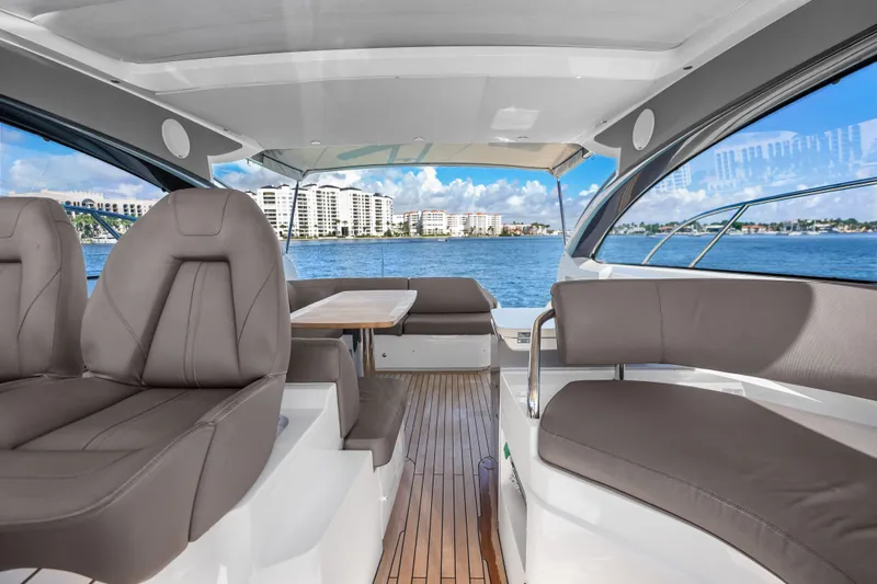 Slide: The Image of Luxurious 2022 Princess V50 yacht interior with elegant seating and scenic ocean view. - 16
