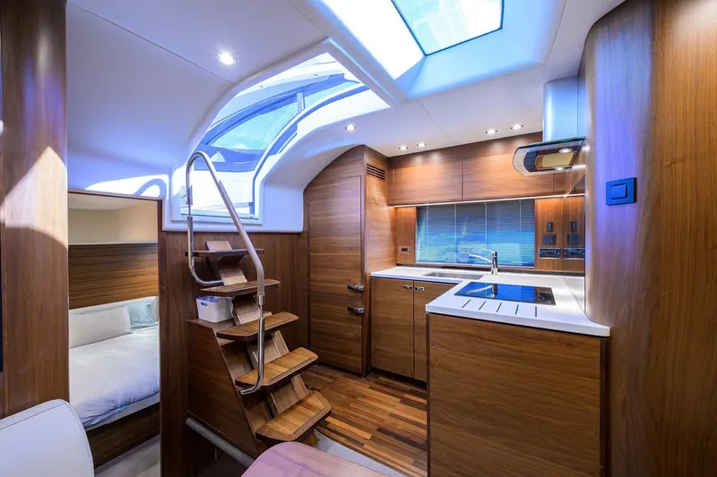 Slide: The Image of Luxurious interior of 2022 Princess V50 Open yacht with modern kitchen and wooden finishes. - 2