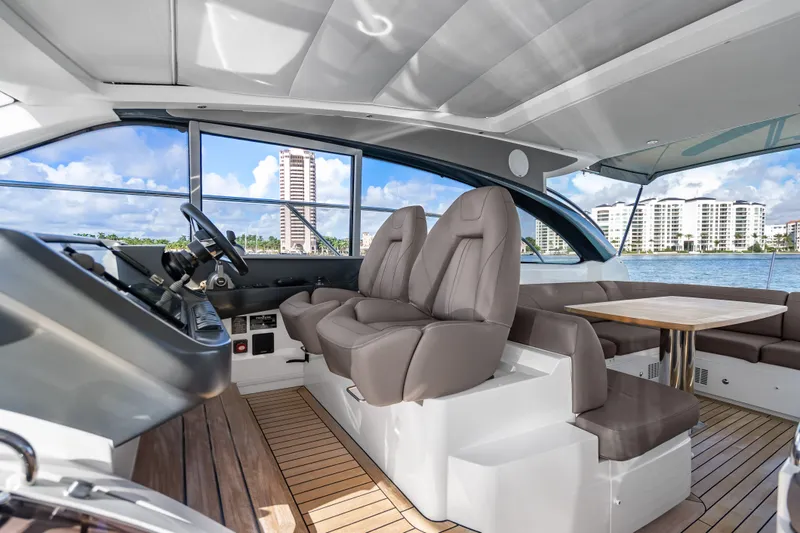Slide: The Image of Luxurious 2022 Princess V50 yacht interior with plush seating and scenic waterfront view. - 31