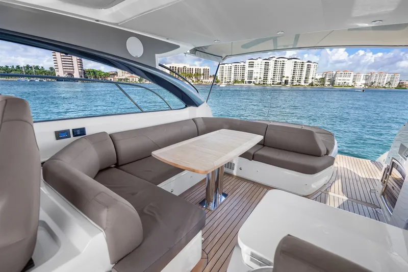 Slide: The Image of Luxurious 2022 Princess V50 yacht interior with elegant seating and scenic waterfront view. - 36