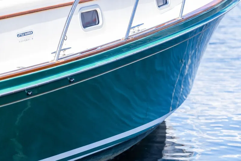 Slide: The Image of Close-up of 2000 Little Harbor WhisperJet 38 boat hull on water. - 7