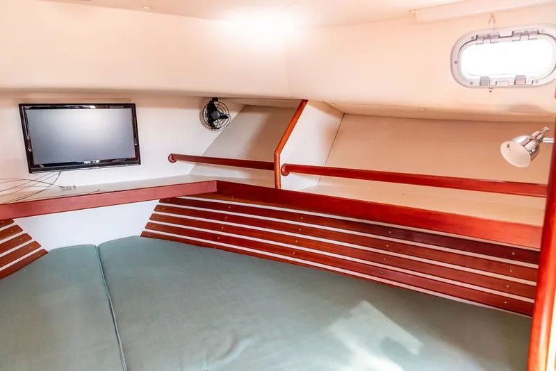 Slide: The Image of Cozy cabin interior of 2000 Little Harbor WhisperJet 38 with TV and wooden accents. - 30