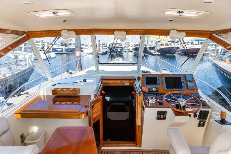 Slide: The Image of Interior view of a 2000 Little Harbor WhisperJet 38 yacht cockpit with wooden accents. - 12
