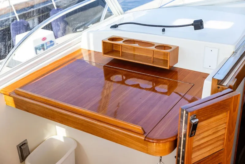 Slide: The Image of Interior of 2000 Little Harbor WhisperJet 38 with polished wooden surfaces and storage compartments. - 13