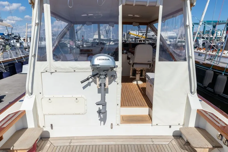 Slide: The Image of Little Harbor WhisperJet 38, 2000 model, docked with Honda outboard motor, wooden deck, and clear canopy. - 9