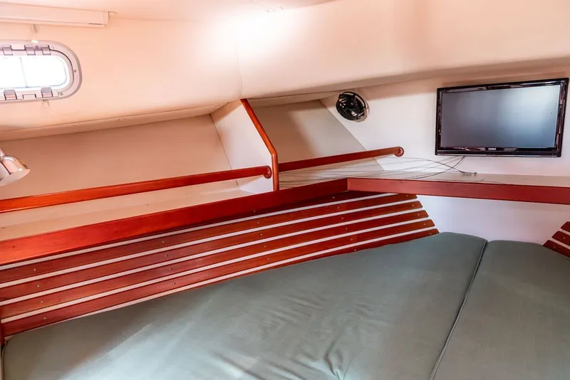 Slide: The Image of Interior cabin of 2000 Little Harbor WhisperJet 38 with wooden accents and mounted TV. - 29