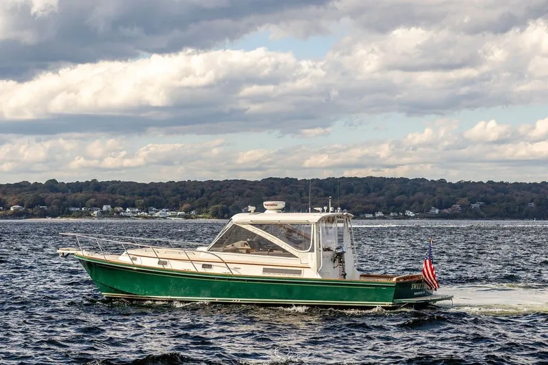 Slide: The Image of Little Harbor WhisperJet 38 boat from 2000 cruising on a scenic lake. - 1