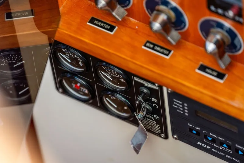 Slide: The Image of Control panel of a 2000 Little Harbor WhisperJet 38 boat, featuring gauges and switches. - 33