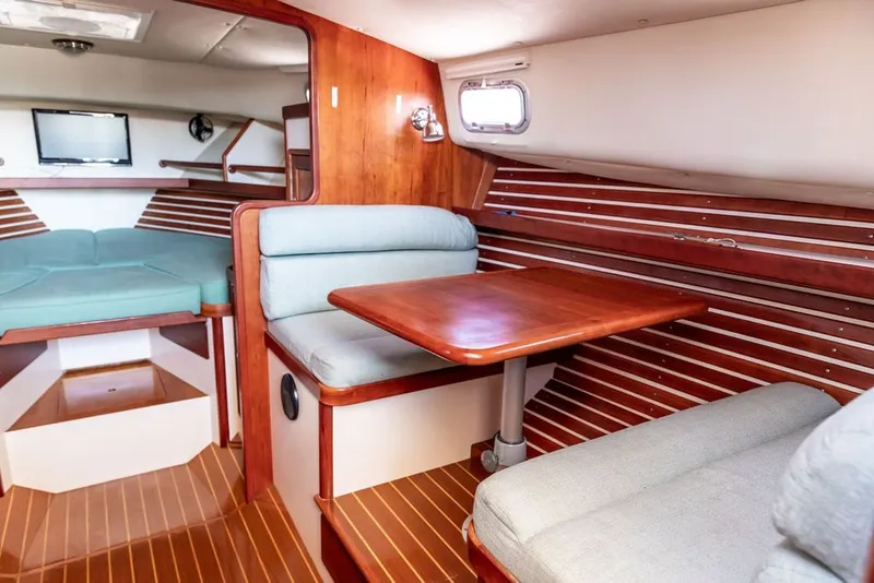 Slide: The Image of Interior of 2000 Little Harbor WhisperJet 38 yacht with wood accents and cozy seating. - 22