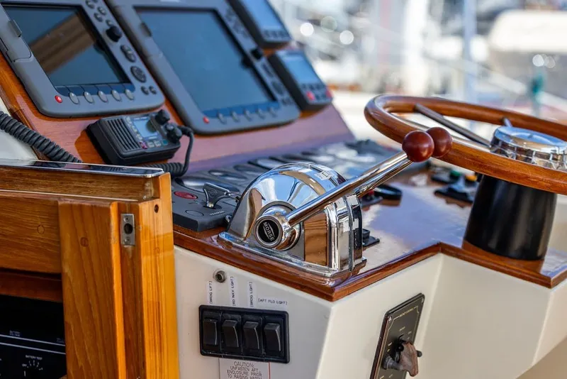 Slide: The Image of Helm of 2000 Little Harbor WhisperJet 38 with navigation controls and wooden steering wheel. - 16