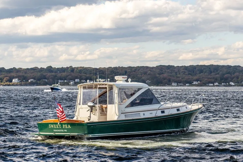 Slide: The Image of Little Harbor WhisperJet 38 boat cruising on a scenic lake, 2000 model. - 2