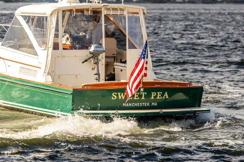 Slide: The Image of Little Harbor WhisperJet 38 boat, 2000 model, named "Sweet Pea" on water, American flag displayed. - 5