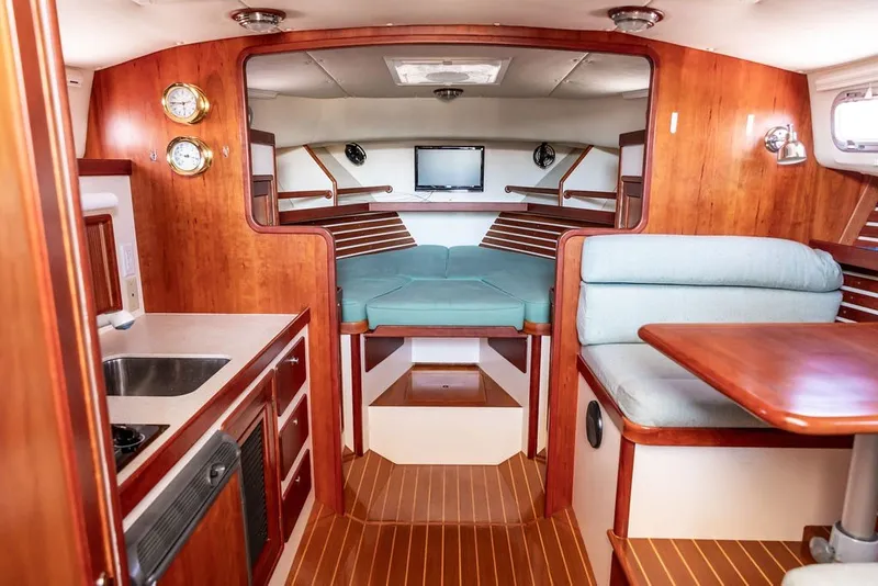 Slide: The Image of Interior of 2000 Little Harbor WhisperJet 38 yacht with wood finish and cozy seating. - 27