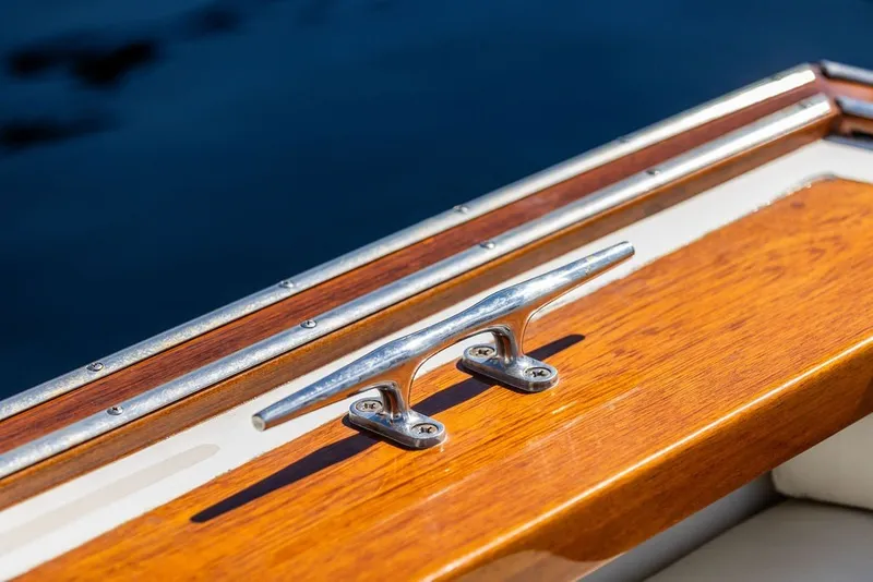 Slide: The Image of Close-up of a 2000 Little Harbor WhisperJet 38 boat's polished wooden deck and cleat. - 37