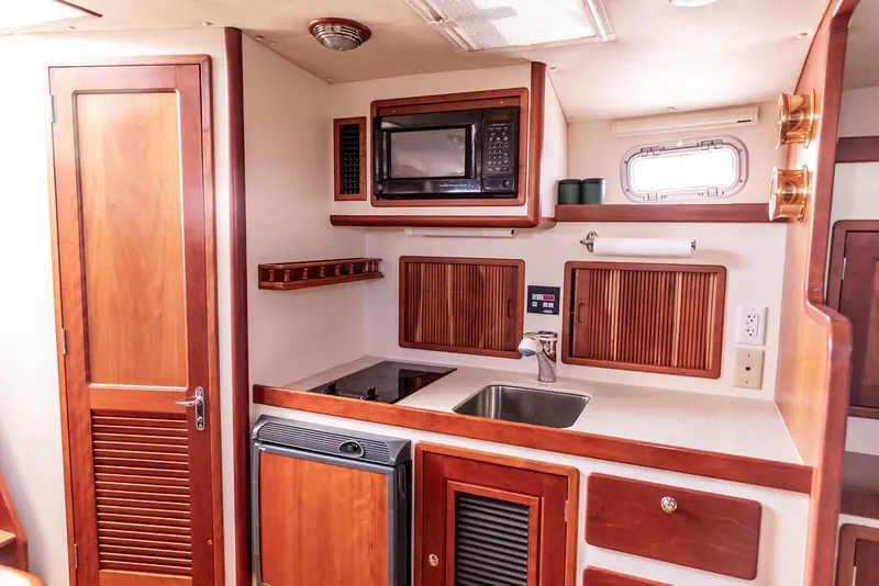 Slide: The Image of Interior of 2000 Little Harbor WhisperJet 38 yacht kitchen with wood cabinetry and appliances. - 21