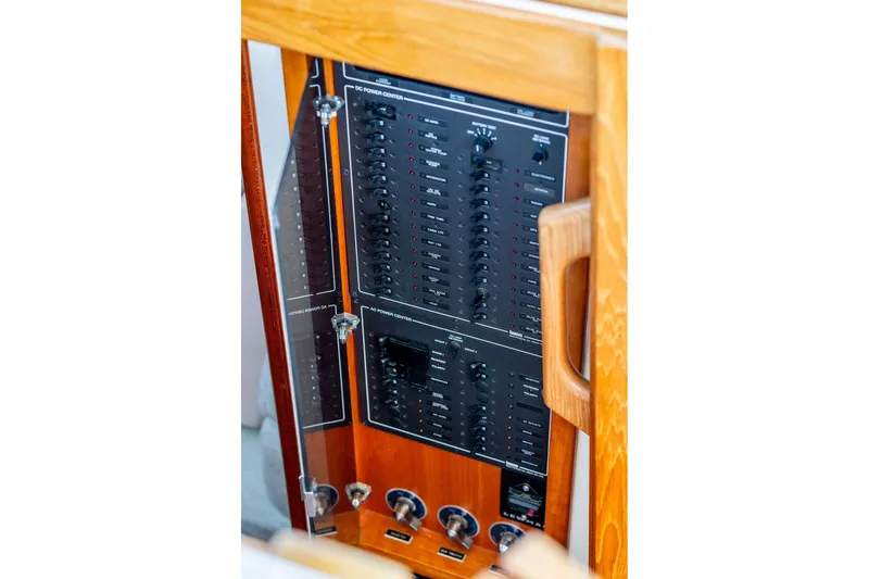Slide: The Image of Electrical panel of a 2000 Little Harbor WhisperJet 38 boat, featuring wooden cabinetry. - 32