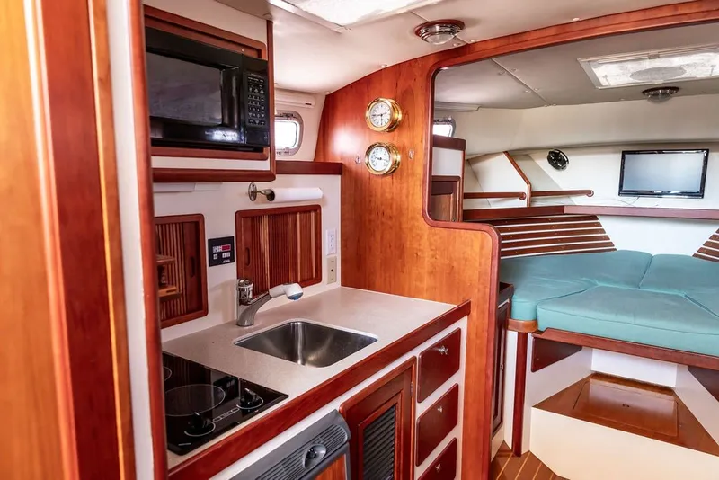 Slide: The Image of Interior of 2000 Little Harbor WhisperJet 38 yacht with kitchenette and cozy seating area. - 19