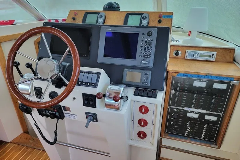 Slide: The Image of Helm of 2005 Compton 33 Downeast Express HT with navigation equipment and controls. - 1