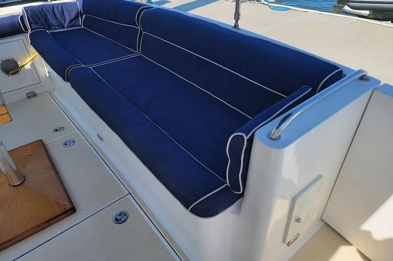 Slide: The Image of 2005 Compton 33 Downeast Express HT boat with blue cushioned seating on deck. - 28