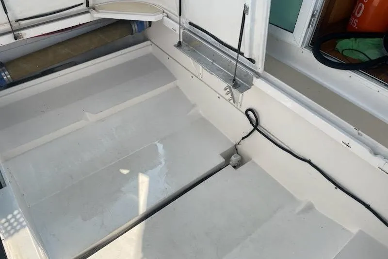 Slide: The Image of 2005 Compton 33 Downeast Express HT boat interior with clean white flooring. - 23