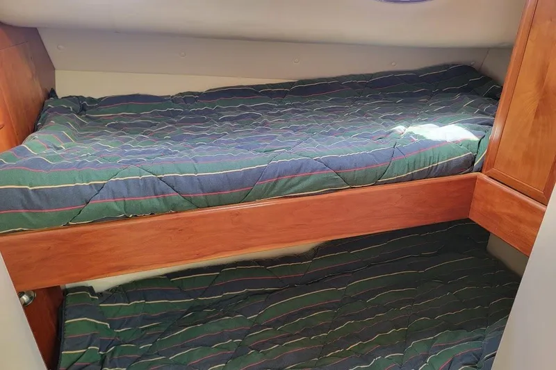 Slide: The Image of Bunk beds in 2005 Compton 33 Downeast Express HT cabin with striped bedding. - 16