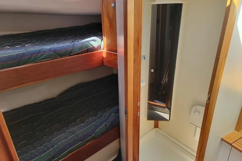 Slide: The Image of Interior of 2005 Compton 33 Downeast Express HT with bunk beds and compact bathroom. - 15