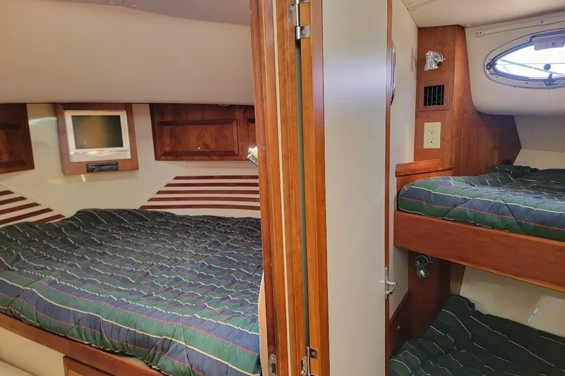 Slide: The Image of Interior of 2005 Compton 33 Downeast Express HT with cozy sleeping quarters. - 12